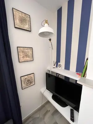 Una televisión o centro de entretenimiento en Dos Hermanas Vera Coast