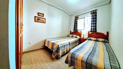Cama o camas de una habitación en Apartamento bajo VERAMAR 2 2ª línea 500 m de la playa