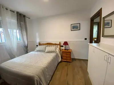 Cama o camas de una habitación en Apartamento a pie de playa