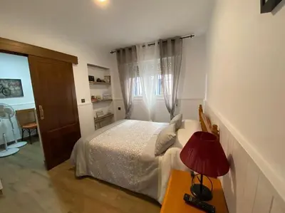 Cama o camas de una habitación en Apartamento a pie de playa
