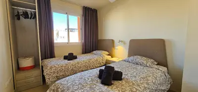 Cama o camas de una habitación en Homes of Spain, Apartamentos Paraiso Vera Playa, Ed Tahiti, Atico B de 2 dormitorios con piscina privada en solárium y barbacoa, pie de playa