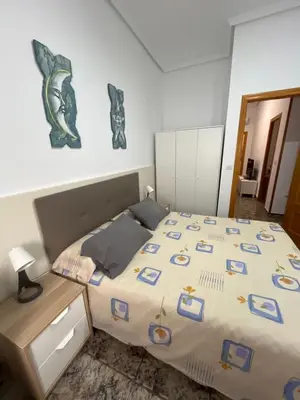 Cama o camas de una habitación en Bonito apartamento cerca de la playa