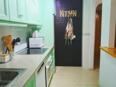 Una cocina o zona de cocina en Bajo con porche en primera línea En Vera, Almeria