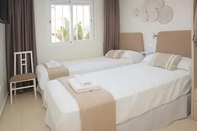 Cama o camas de una habitación en Palami Vera con terraza, WIFI 300mb, piscina y garaje privado