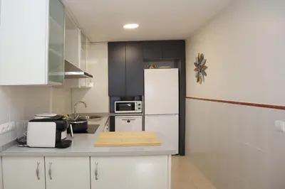 Una cocina o zona de cocina en Palami Vera con terraza, WIFI 300mb, piscina y garaje privado