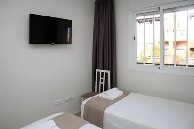 Cama o camas de una habitación en Palami Vera con terraza, WIFI 300mb, piscina y garaje privado