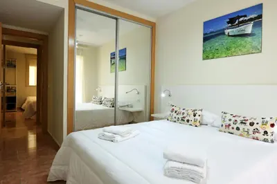 Cama o camas de una habitación en Vera Playa Bajo 2 Terrazas Jardín Piscina Parking