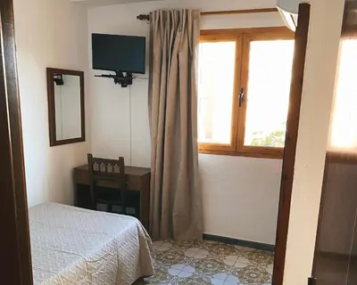 Cama o camas de una habitación en Pensión Torrecárdenas