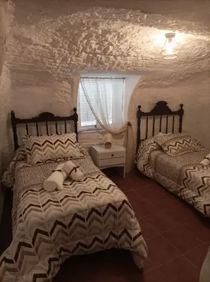 Cama o camas de una habitación en Cueva la Trapera