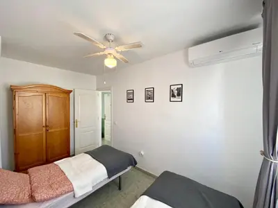 Cama o camas de una habitación en Fuentemar Duplex - WiFi, terraza & piscina comunitaria