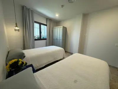 Cama o camas de una habitación en CASA YANGUAS APARTAMENTOS RURALES EN LAUJAR DE ANDARAx