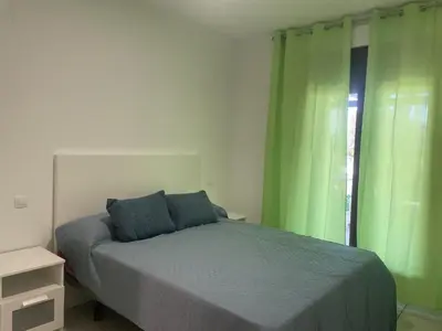 Cama o camas de una habitación en APARTAMENTO BAJO TERRAZA URBANIZACION ACCESO DiRECTO PLAYA