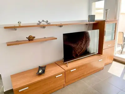 Una televisión o centro de entretenimiento en Candela 53 Dúplex con terraza y piscina
