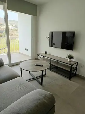 Una televisión o centro de entretenimiento en Piso en Primera línea de playa