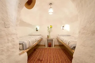 Cama o camas de una habitación en RentitSpain - Guadix - Cueva Oliva Relax e Historia entre las Montañas
