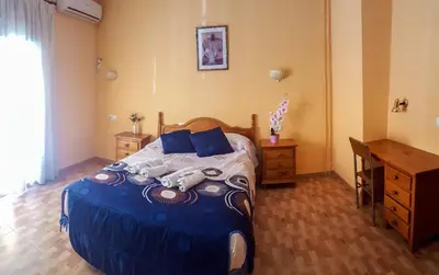 Cama o camas de una habitación en Hostal rural El Caminero