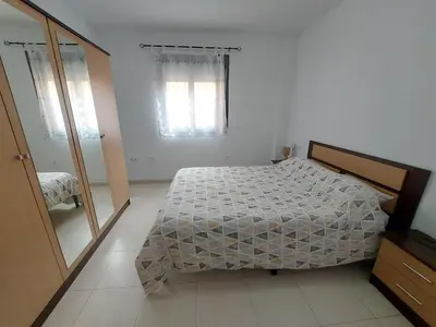 Cama o camas de una habitación en Apartamento Alborania II con patio gande y aparcamiento, entre el mar y del desierto