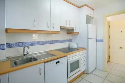 Una cocina o zona de cocina en Mediterranea 14 Vera Playa Jardines tus momentos frente al mar
