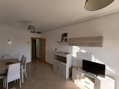 Una televisión o centro de entretenimiento en APARTAMENTOS TURISTICOS 3ºD CARLOS III - Cerca de la playa