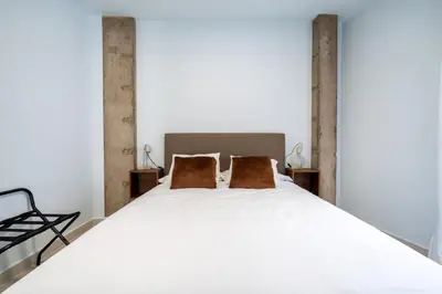 Cama o camas de una habitación en Moott Homes Suites Arco de Braulio 1B