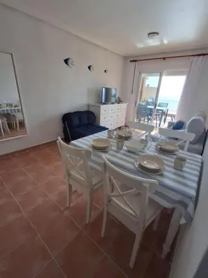 Una televisión o centro de entretenimiento en Golf Marina de la Torre con vistas al mar