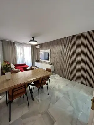 Una televisión o centro de entretenimiento en Apartamento a un paso de la playa