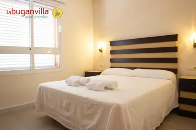 Cama o camas de una habitación en Apartamentos la Buganvilla