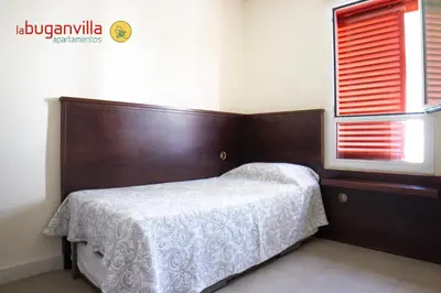Cama o camas de una habitación en Apartamentos la Buganvilla
