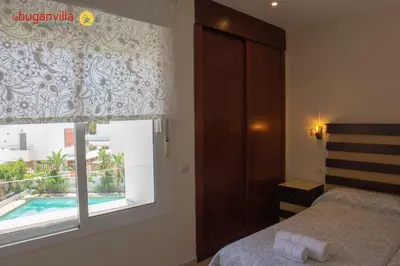 Cama o camas de una habitación en Apartamentos la Buganvilla