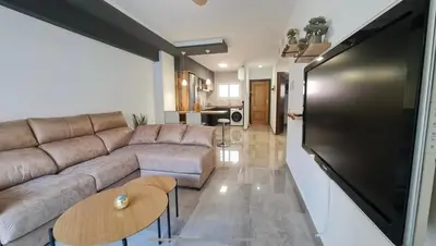 Una televisión o centro de entretenimiento en Apartamento con Piscina