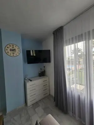 Una televisión o centro de entretenimiento en Apartamento Costa Azul VERA