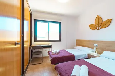 Cama o camas de una habitación en Apartamento con terraza y piscina en Los Collados - By Aloha Palma