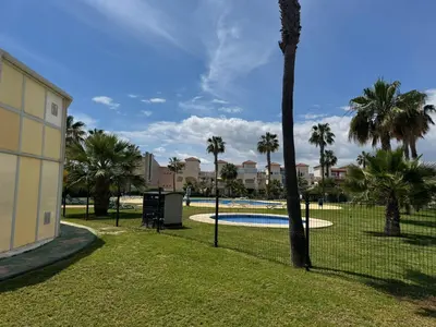Piscina en o cerca de Apartamento TorreMar Natura Urbanización Naturista, Piscina Climatizada, Bajo con Jardín, Parking