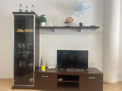 Una televisión o centro de entretenimiento en Apartamento con Terrazas y vistas al mar