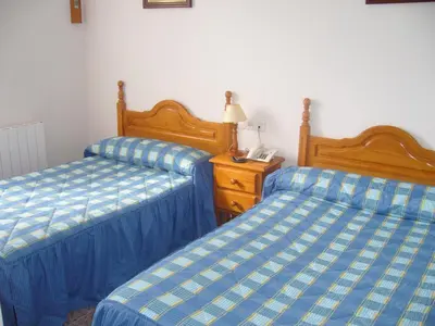 Cama o camas de una habitación en Hostal Casa Grande