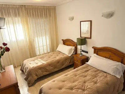 Cama o camas de una habitación en Hotel Mesón el 21