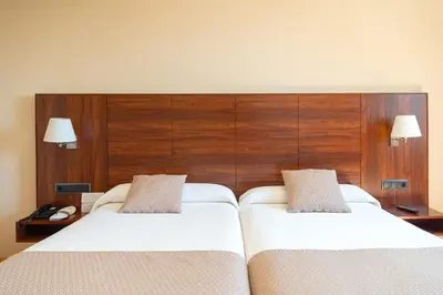 Cama o camas de una habitación en Sercotel Riscal