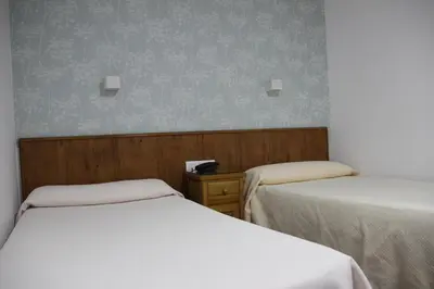 Cama o camas de una habitación en Hostal Maribel