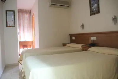 Cama o camas de una habitación en Hostal Maribel