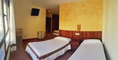 Cama o camas de una habitación en Hostal Mulhacén