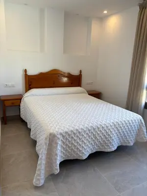 Cama o camas de una habitación en Hostal Mulhacén