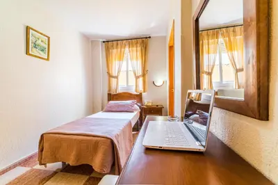 Cama o camas de una habitación en Hotel Sevilla