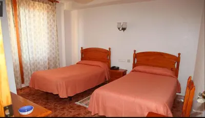 Cama o camas de una habitación en Hotel Los Arcos