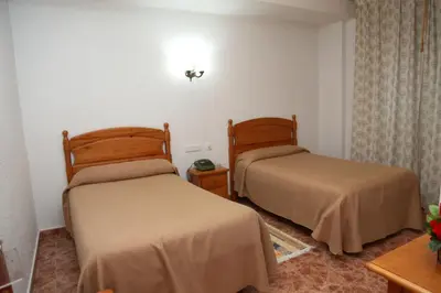 Cama o camas de una habitación en Hotel Los Arcos