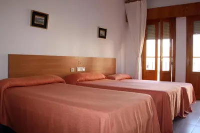 Cama o camas de una habitación en Hotel Los Arcos