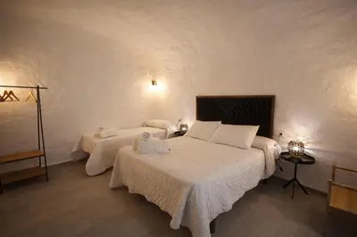 Cama o camas de una habitación en Alojamientos Cuevas Pinomojon