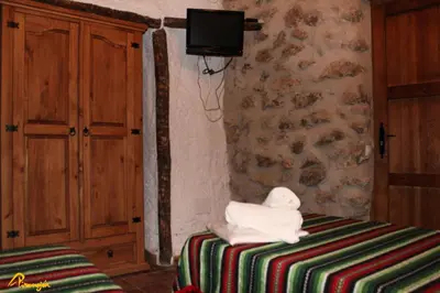 Cama o camas de una habitación en Alojamientos Cuevas Pinomojon