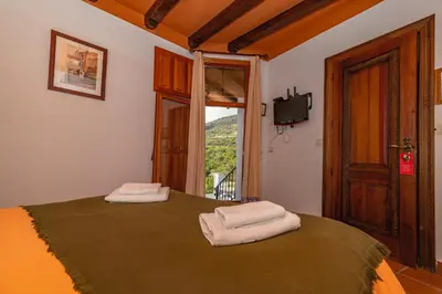 Cama o camas de una habitación en Hotel La Fragua I
