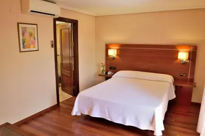 Cama o camas de una habitación en Hotel Mari Carmen