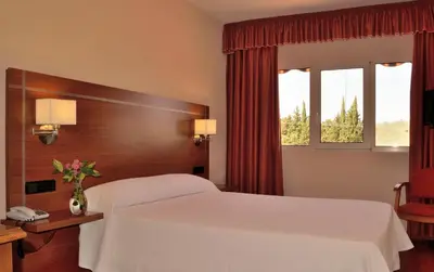 Cama o camas de una habitación en Hotel Mari Carmen